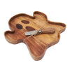 acacia wood serving board shaped like a ghost with an iron spreader