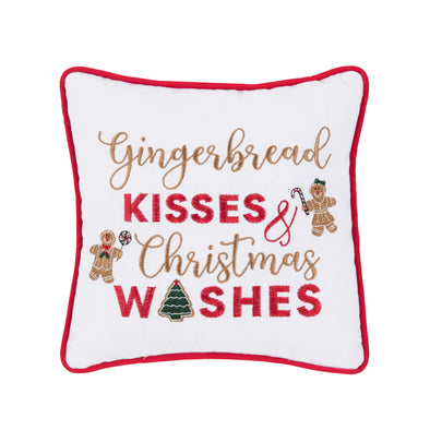 embroidered pillow trimmed in red with the phrase gingerbread kisses and christmas wishes on a white background surrounded by embroidered gingerbread man and gingerbread woman