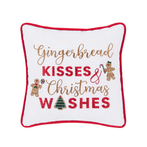 embroidered pillow trimmed in red with the phrase gingerbread kisses and christmas wishes on a white background surrounded by embroidered gingerbread man and gingerbread woman