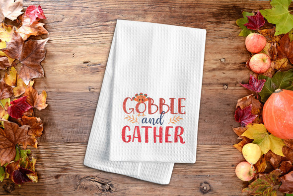 Embroidered Gobble and Gather kitchen towel styled on a fall flatlay.