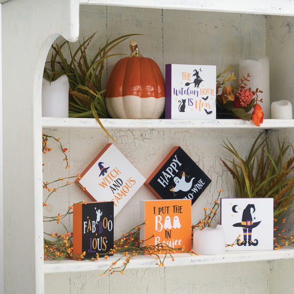 Halloween shelf blocks displayed on a shelf surrounded by other fall decor