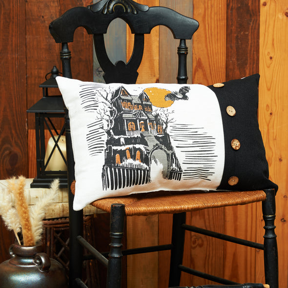 Haunted House printed pillow styled on a wooden chair.