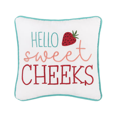 mini white pillow that says hello in light blue, sweet in peach and cheeks in red embroidered with light blue piping around the edges with a strawberry by the word hello