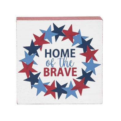 shelf block with home of the brave text in the center surrounded by a wreath of stars in shades of blue and red