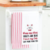 flour sack towel embroidered with a roses are red poem below a cat hanging from a kitchen counter