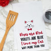 flour sack towel embroidered with a roses are red poem below a cat on a marble kitchen counter