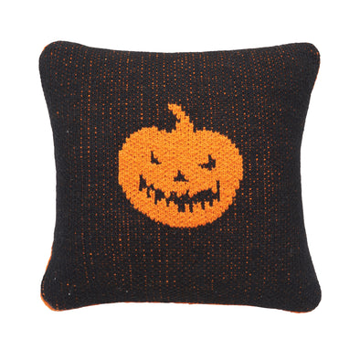 black knitted mini pillow with an orange jack-o-lantern