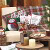 woodland Christmas creatures on pillows and throws sitting on a couch in a festive winter scene