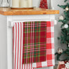 red and green woven plaid kitchen towel hanging from a kitchen counter next to other holiday kitchen towels