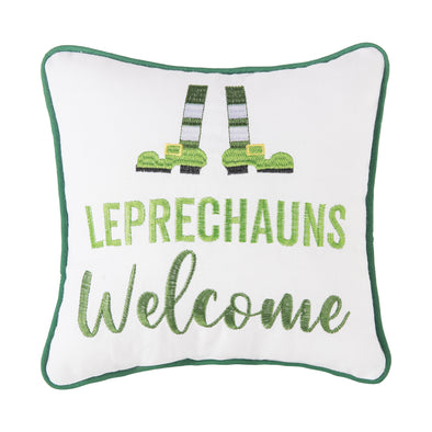 white pillow with green piping border with a pair of leprechaun legs and shoes with the words "leprechauns welcome" written in two different shades of green