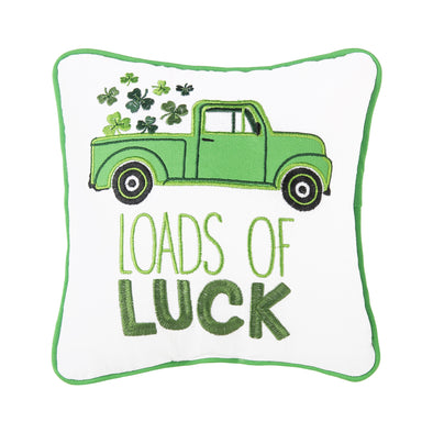 white pillow with green border picturing a green truck with shamrocks coming out of the back with the words "loads of luck" in green
