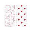 printed valentine's day towel set with different designs. one towel has love repeated in flourishing text while the second has an all over heart pattern