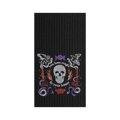 black waffle weave towel with a skull and the phrase you have magic in your bones surrounded by mystical elements