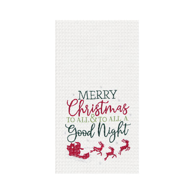 waffle weave towel with the phrase Merry Christmas to All & To All a Good Night in different fonts above Santa in his sleigh flying with his reindeer