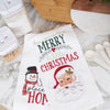 embroidered flour sack towel with the phrase have yourself a merry little Christmas above Santa's face paired with a waffle weave snowman towel