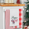 waffle weave towel with an owl bundled in winter gear next to the phrase peace to all hanging from a kitchen countertop