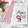 waffle weave towel with an owl bundled in winter gear next to the phrase peace to all on a marble countertop