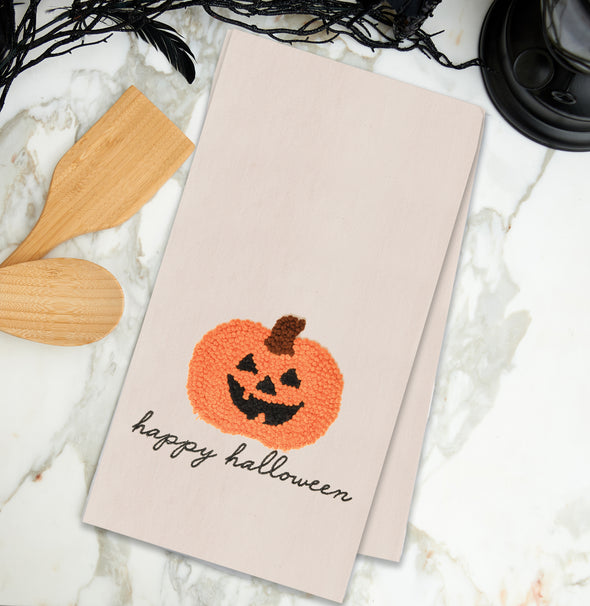 pumpkin french knot kitchen towel styled on a marble countertop