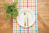 Radley Plaid woven table runner styled with serve ware and greenery.