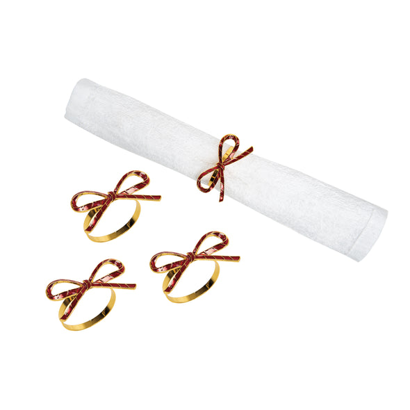 napkin rings shaped like red ribbons - one wrapped around white napkin