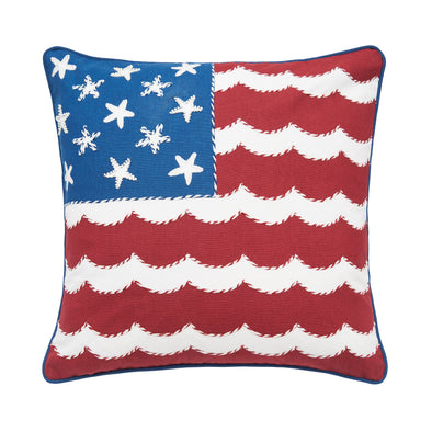 a printed and embellished pillow that resembles the American flag but features starfish for the stars and white waves as the stripes.