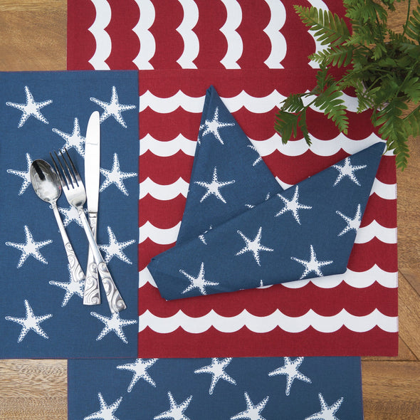 printed table linens that resemble a flag with starfish for the stars and white waves instead of stripes