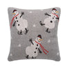 grey knitted pillow with snowmen in ice skates and red scarfs