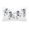 reversible knitted pillow featuring dancing skeletons. one side features skeletons with black bones on a white background while the reverse features the opposite.