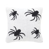 knitted pillow with black spiders on a white background