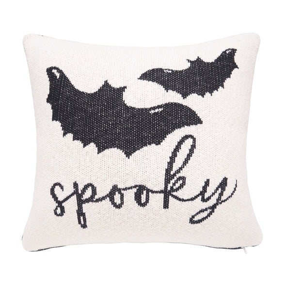 white knitted pillow with the word spooky and two flying bats