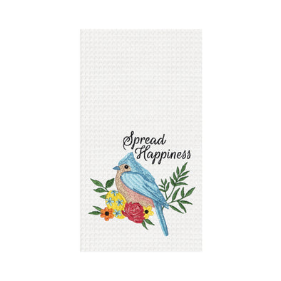 white waffle weave towel with a blue bird on a tree branch with flowers and an easter egg under the words "spread happiness" in black