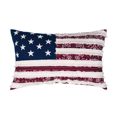 an applique pillow resembling the American flag, this pillow has a traditional red bandana pattern under a series of white fringed stripes.