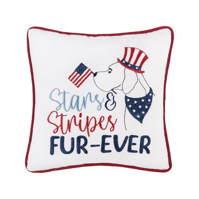 embroidered pillow with a picture of a dog wearing an Uncle Sam top hat and wearing a blue bandana scarf around its neck and holding an American flag in its mouth paired with the words stars & stripes fur-ever