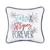 an embroidered pillow with blue and red flourishing text on a white background surrounded by bursts of red and blue fireworks and trimmed in a complementary blue