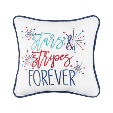 an embroidered pillow with blue and red flourishing text on a white background surrounded by bursts of red and blue fireworks and trimmed in a complementary blue