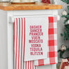 embroidered flour sack towel listing some of Santa's famous reindeer along with names of popular liquors in red embroidery hanging from a kitchen countertop