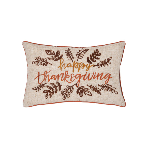 embroidered pillow with the words Happy Thanksgiving in cursive font surrounded by abstract delicate foliage all in rustic hues