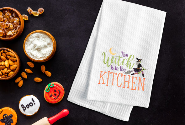 The Witch is in the Kitchen, kitchen towel styled in a Halloween flatlay.