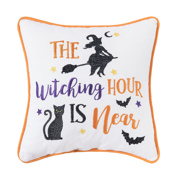 embroidered mini pillow with Halloween icons including a witch flying on a broom, black cat, bats, and the phrase The Witching Hour Is Near