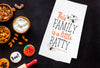 This Family is a Little Batty kitchen towel styled on a Halloween flatlay.