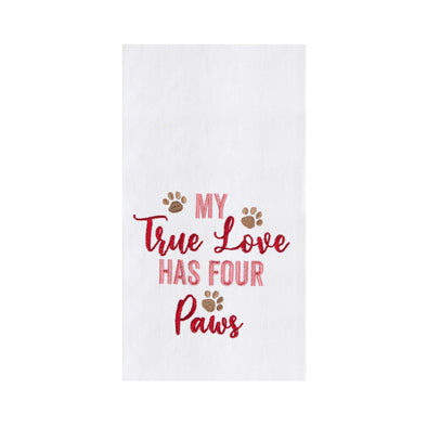 white kitchen towel with "my true love has four paws" embroidered in pink and red with brown paw prints 