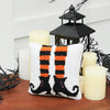 Witch Feet Mini Hooked Pillow styled on a Halloween themed side table.