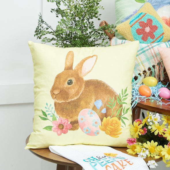 yellow floral bunny pillow on a table