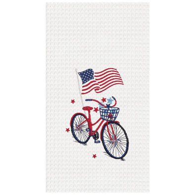 a patriotic waffle weave kitchen towel with a bike surrounded by stars and a waving flag