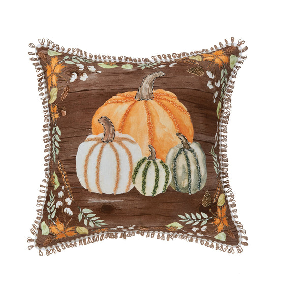 Fall throw pillow featuring embellished pumpkins on a wood grain background.
