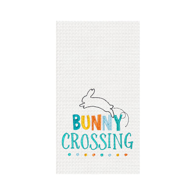 bunny crossing sentiment and hopping bunny icon embroidered on a white waffle weave kitchen towel
