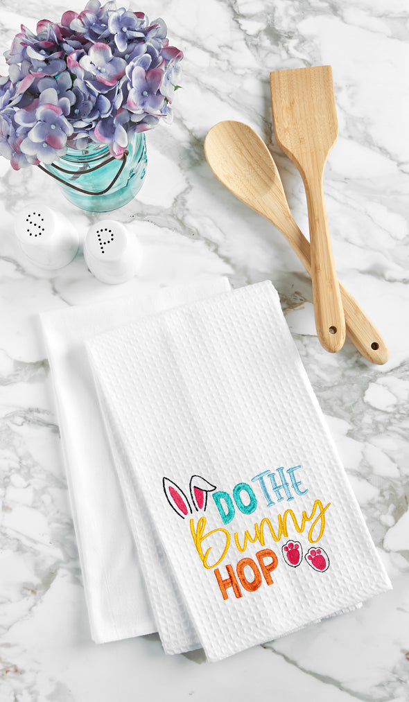 do the bunny hop embroidered on a white waffle weave kitchen towel