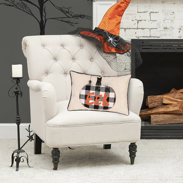 halloween throw pillow featuring a franklin plaid pumpkin styled on a chair